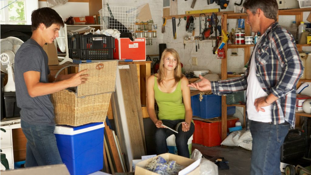 father trying to organise cluttered garage